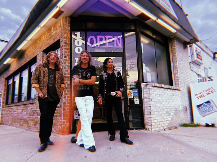 The Black Moods outside a storefront