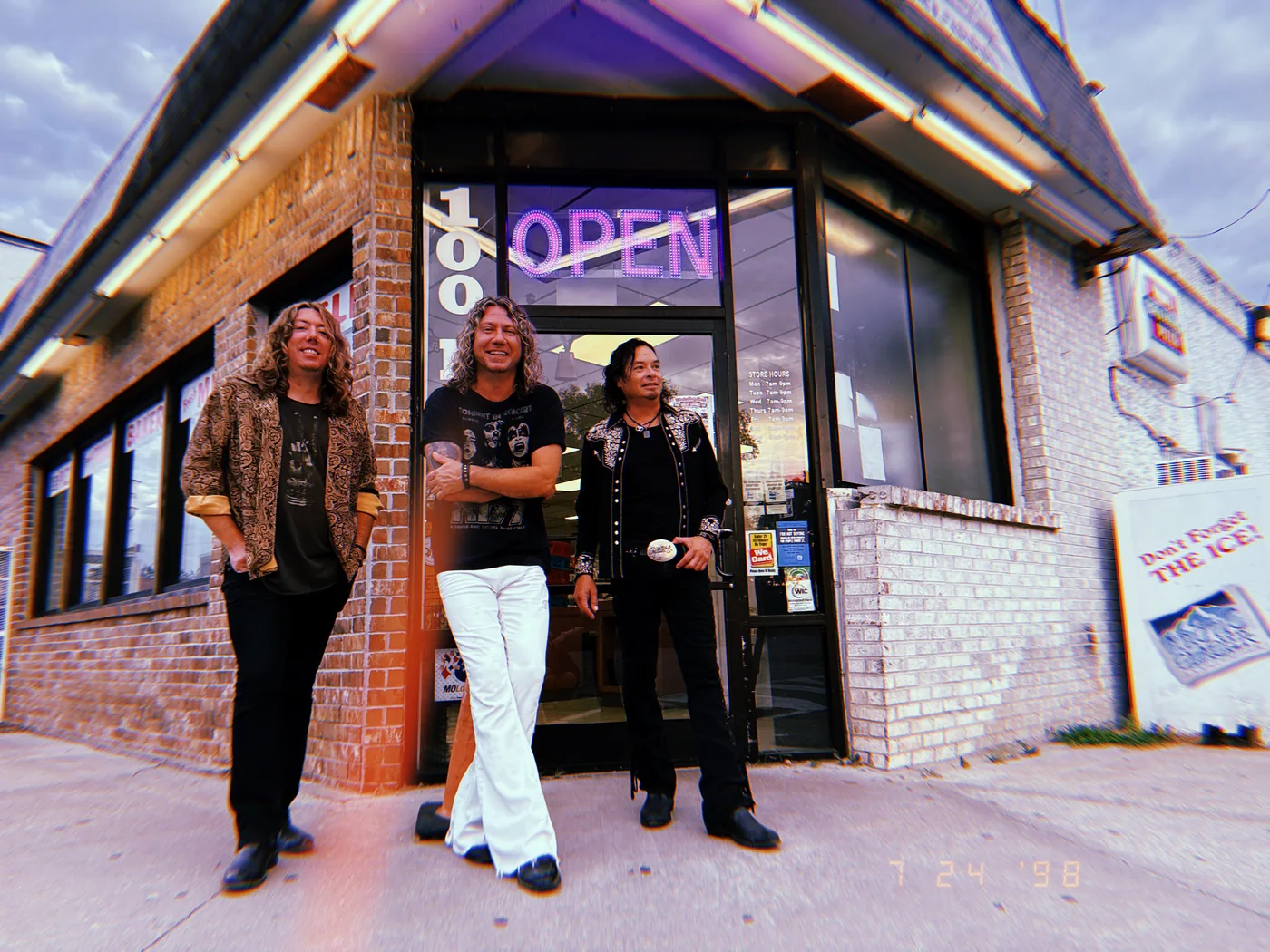 The Black Moods outside a corner store on the road